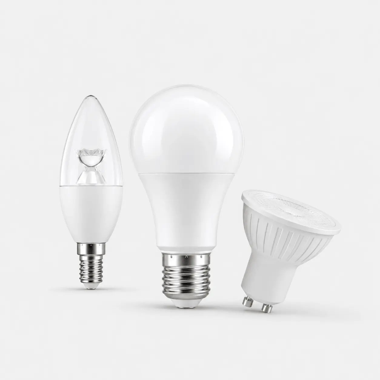 Three different types of LED light bulbs on a white background